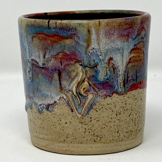 Ceramic refillable candle jar with artistic design on a white background