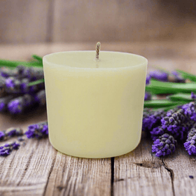 White candle refill on a wooden surface with lavender flowers
