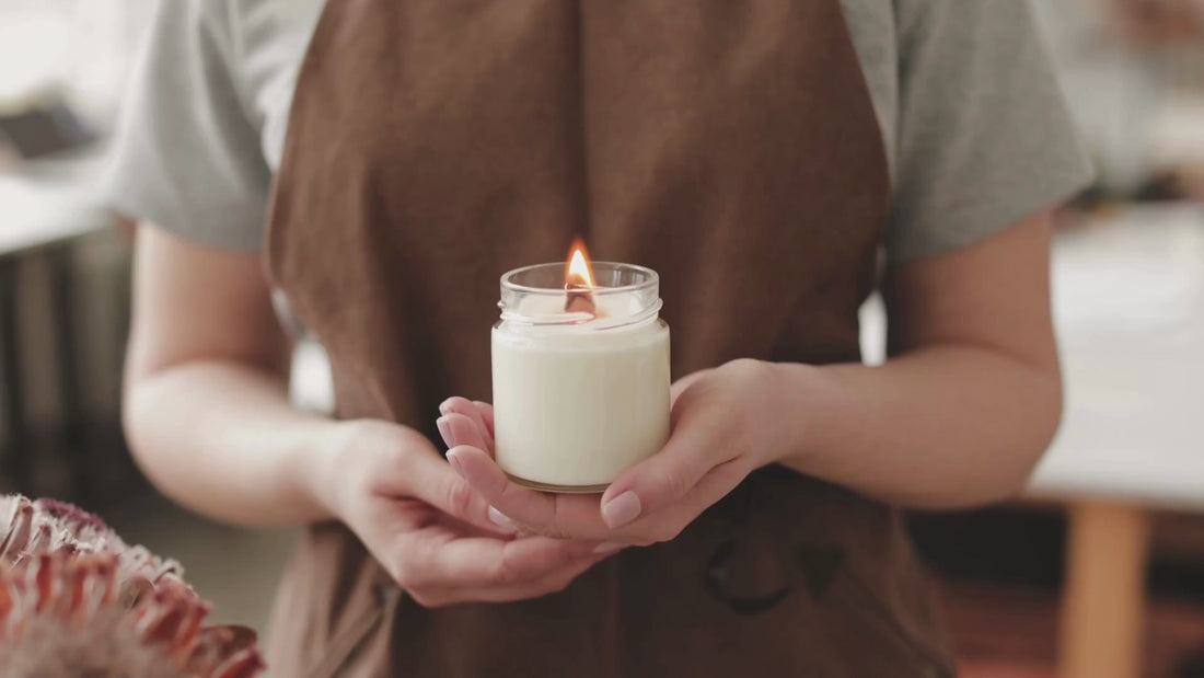 Woman holding white burning candle